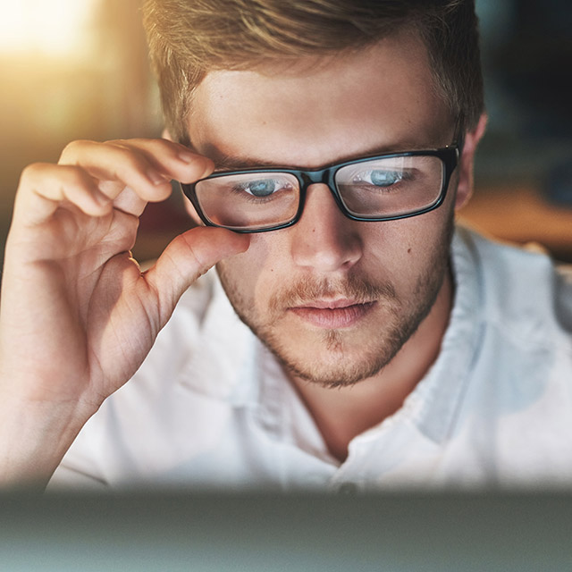 Man with spectacles using notebook