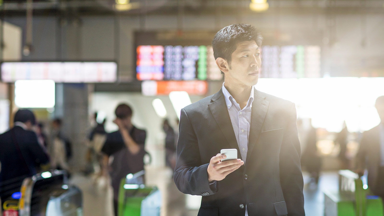 Man at the airport searching on mobile app